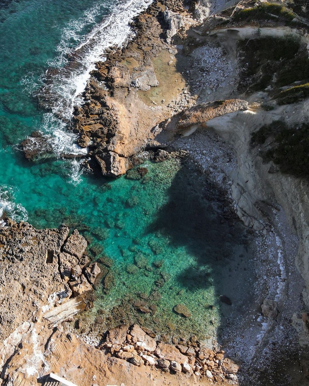 Aerial view of rocks and turquoise water on the Jávea coast